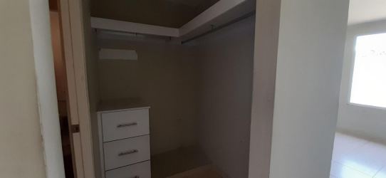 Master bedroom with tiled floor and ensuite bathroom in house for sale Residencial Arboledas La Chorrera