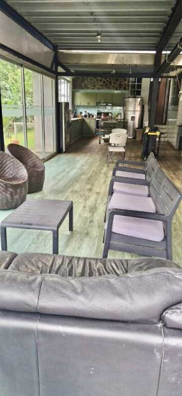 Open-plan living dining area industrial style with glass doors to patio in Cerro Viento Panama house