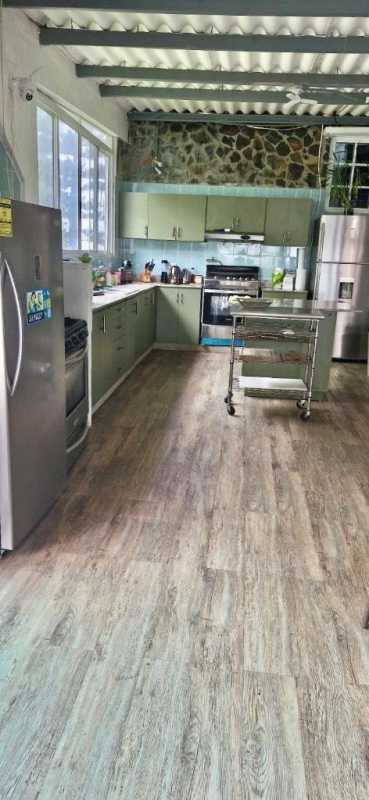 Enclosed patio or sunroom with hammocks, garden views and rustic style Cerro Viento Panama house for sale