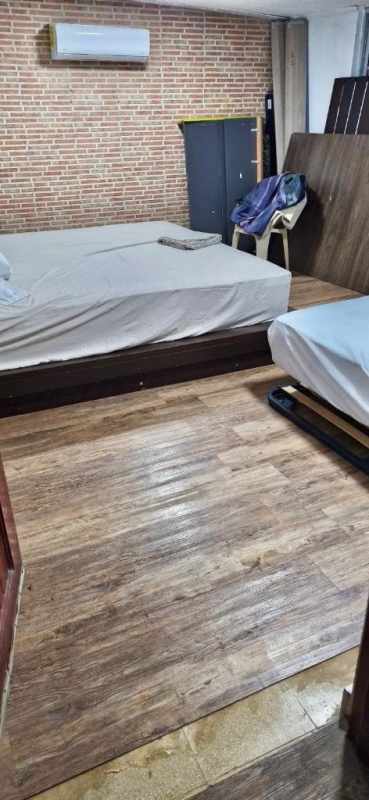 Spacious rustic-style kitchen with large windows, stone accent wall, stainless appliances and rolling island in Cerro Viento house for sale