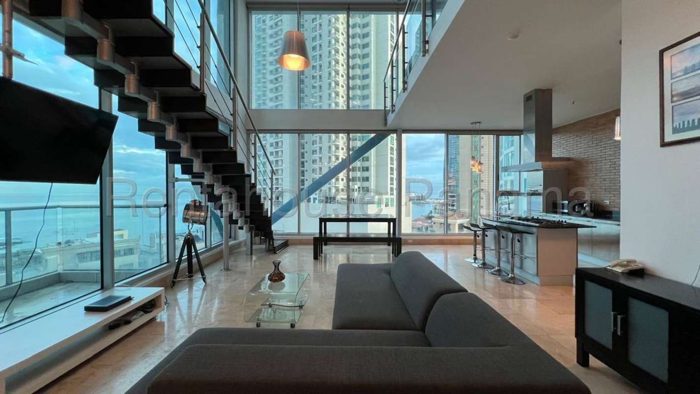 Modern master bedroom loft, floor-to-ceiling windows ocean and city views for sale Panama