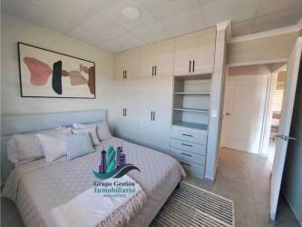 Simple modern kitchen with L counter and window in Brisas del Sur house David Panama