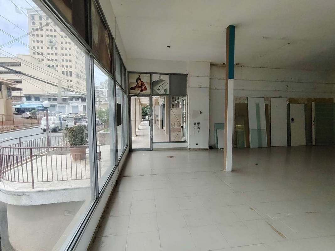 Empty ground floor retail area with tiled flooring and large display front