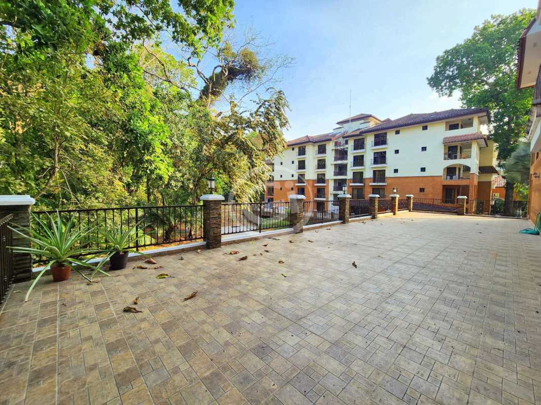 Spacious tiled outdoor terrace with garden views and balconies at Embassy Club Courtyard Clayton Panama