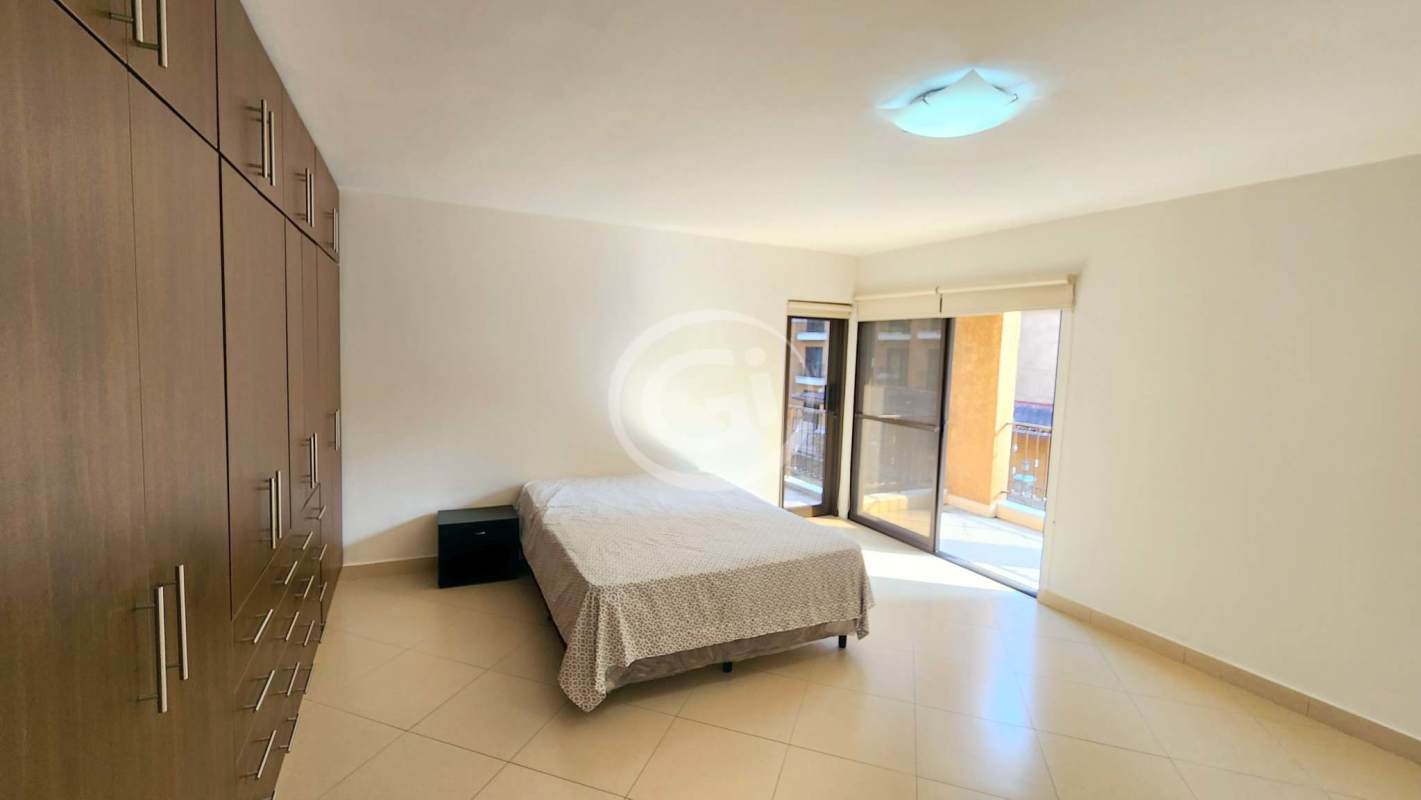 Open plan living dining area with sofas, wood dining set, breakfast bar Embassy Club Courtyard