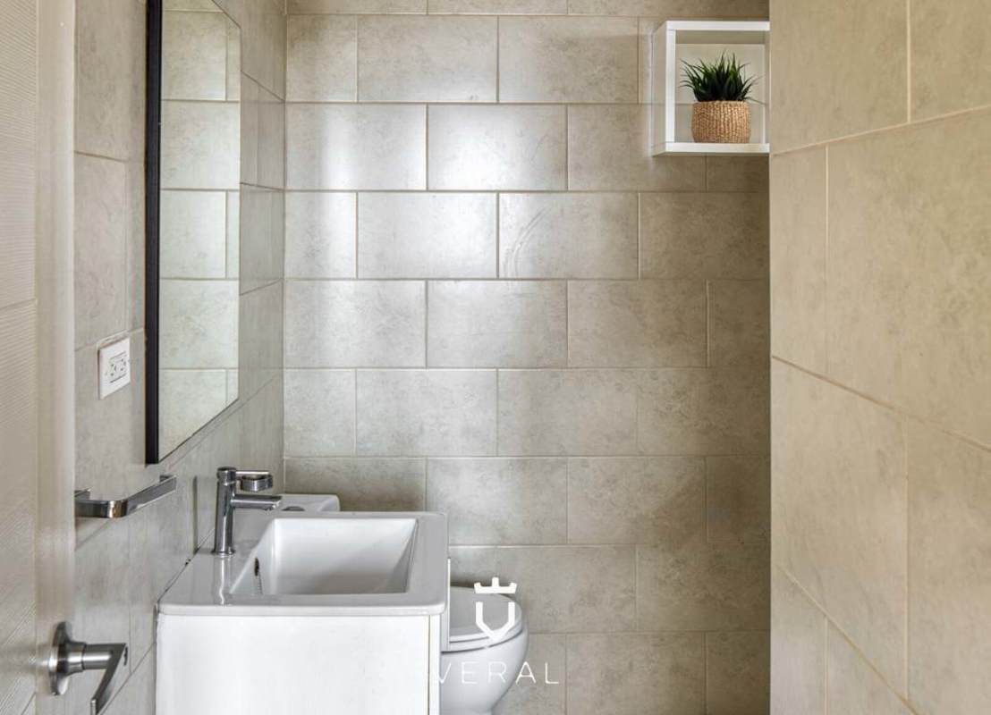 Contemporary bathroom with glass shower enclosure and marble finish at PH Bay View Panama