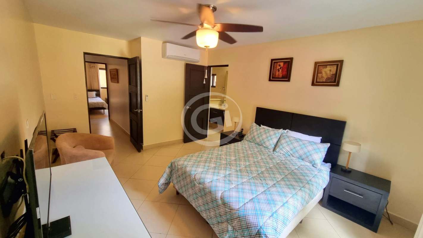 Resort-style swimming pool surrounded by lush gardens at Embassy Club Clayton