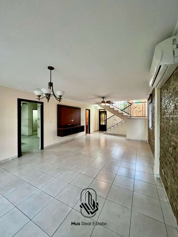 Bright spacious living room with stone accent wall ceiling fan and large windows in PH Castel Novo Chanis Panama