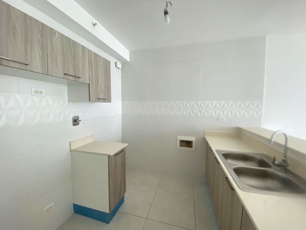 Bright living room with ceramic tile floors and balcony access in PH Viviendi Green Panama City