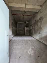 Empty unfinished concrete interior of retail shell unit in Wesland Mall Arraiján