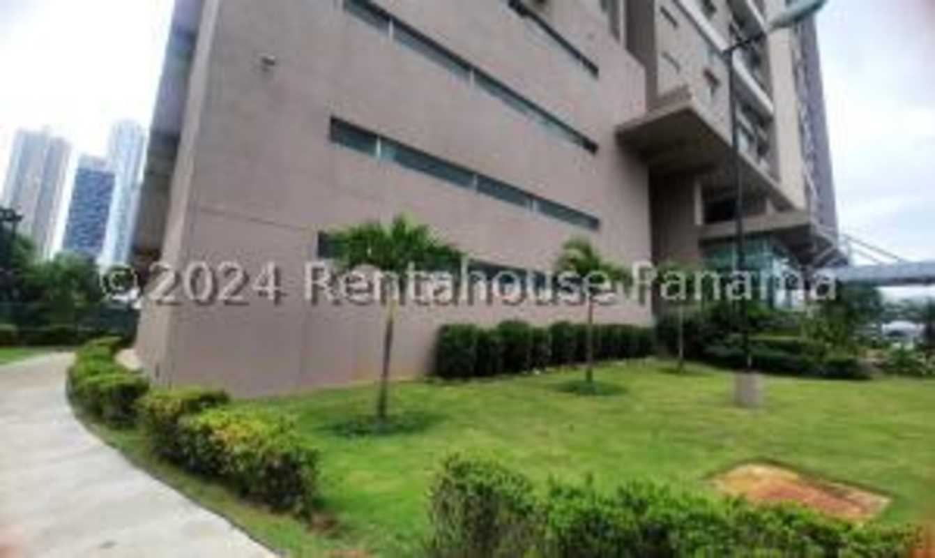 Galley kitchen with black granite countertops wood cabinets in PH Sevilla Costa del Este Panama