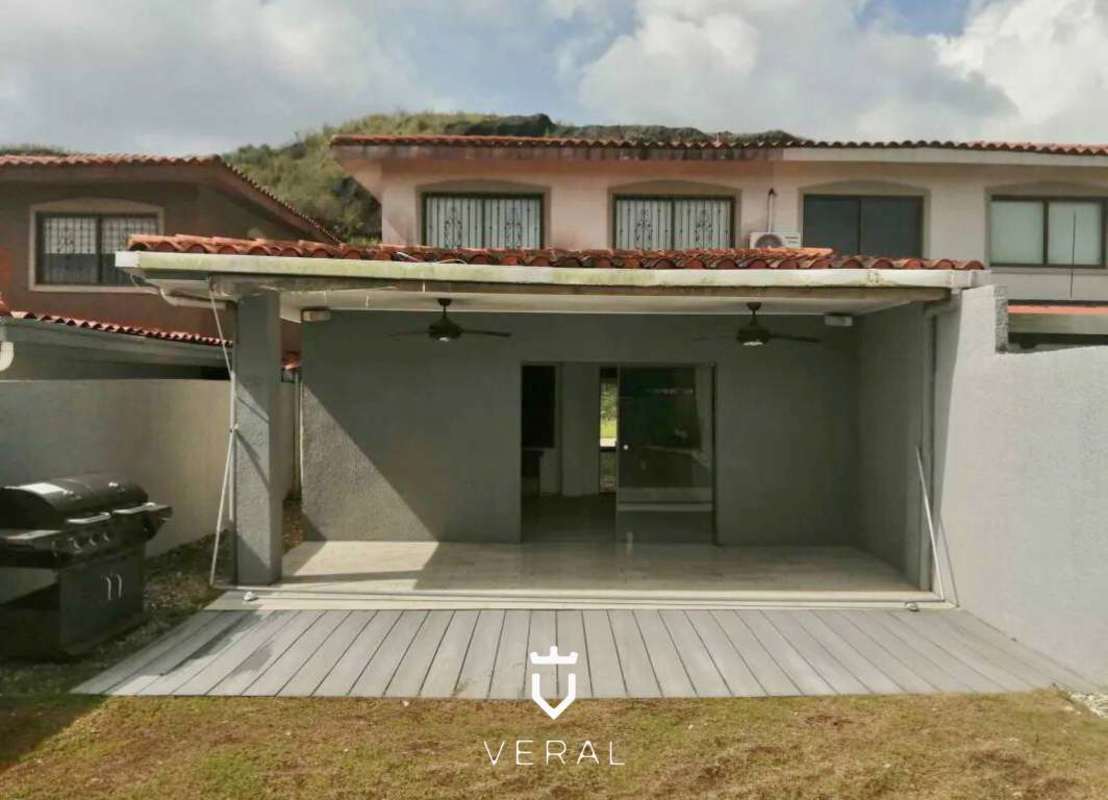 Bright kitchen with light wood cabinets, double sink, and window in Green Village house Milla 8 Panama