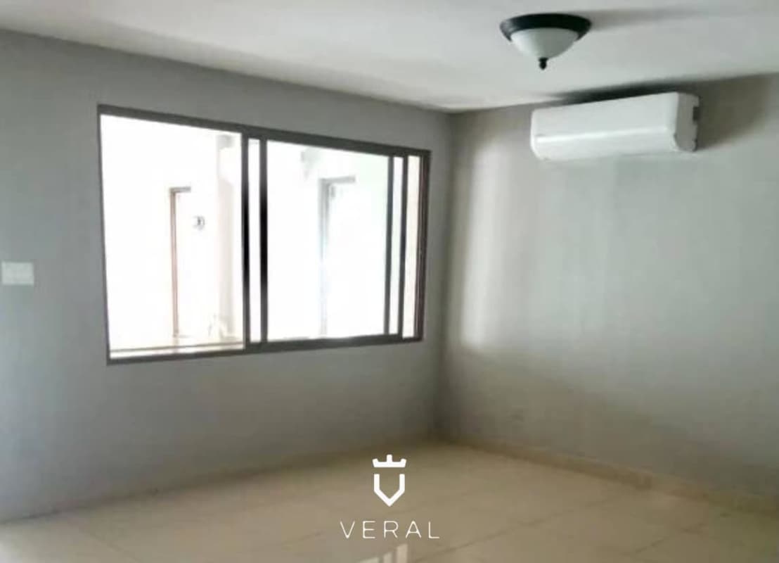 Bedroom with split AC, large window, neutral décor at Green Village house for rent Milla 8 Panama