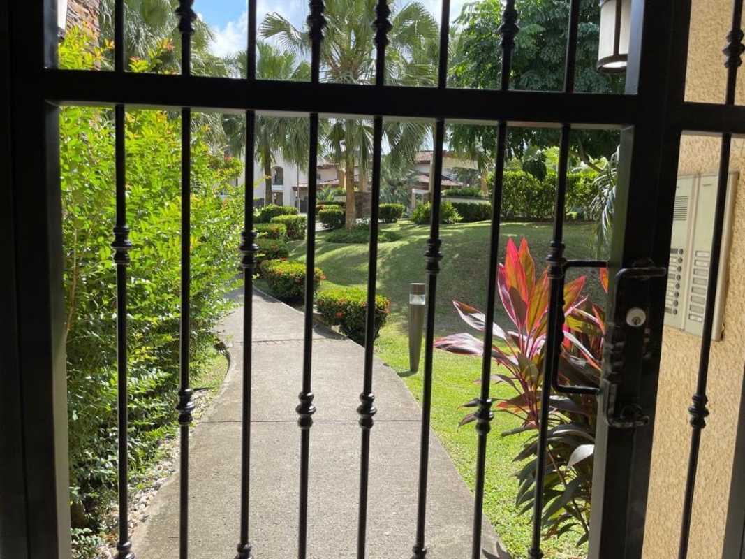 Security gate overlooking lush tropical gardens at Embassy Club Clayton Panama