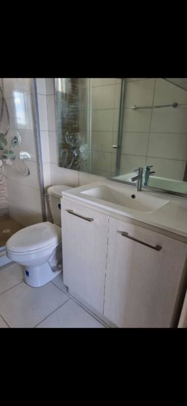 Modern bathroom with glass shower enclosure and tiled walls apartment rental Panama City