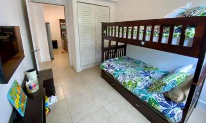 Family bedroom with bunk beds closets TV Rio Mar oceanfront flat Panama
