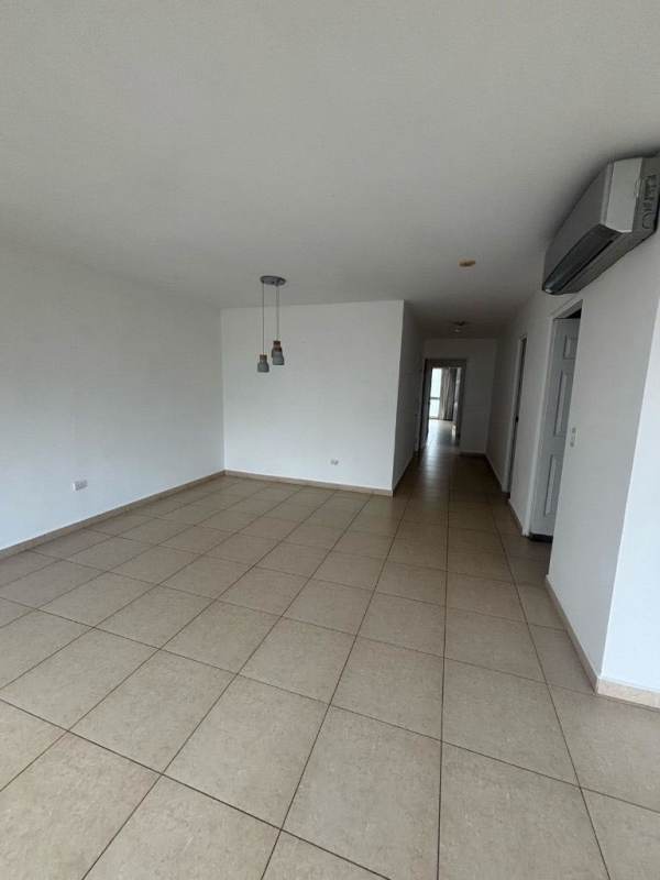 Spacious living room with large windows and city skyline views in PH Sol del Este Costa del Este Panama