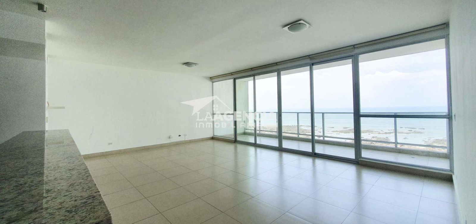 Bright living room with floor-to-ceiling windows and sea views at Oceanaire Panama City