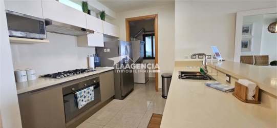 Contemporary dining zone with woven chairs and breakfast bar Casamar resort apartment rental Panama