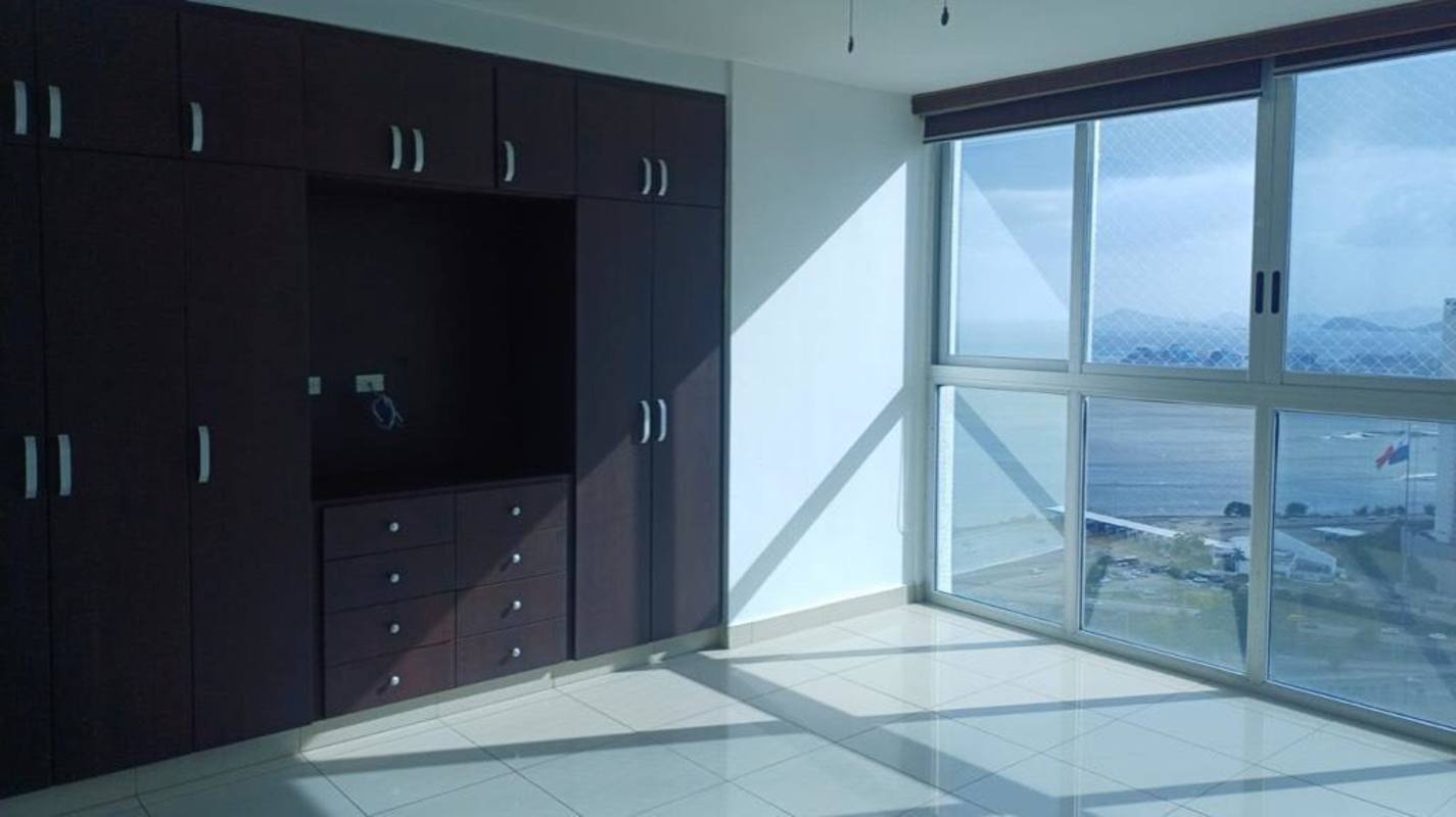 Modern dining area with large windows showing skyline and bay in PH Waterfalls Coco del Mar