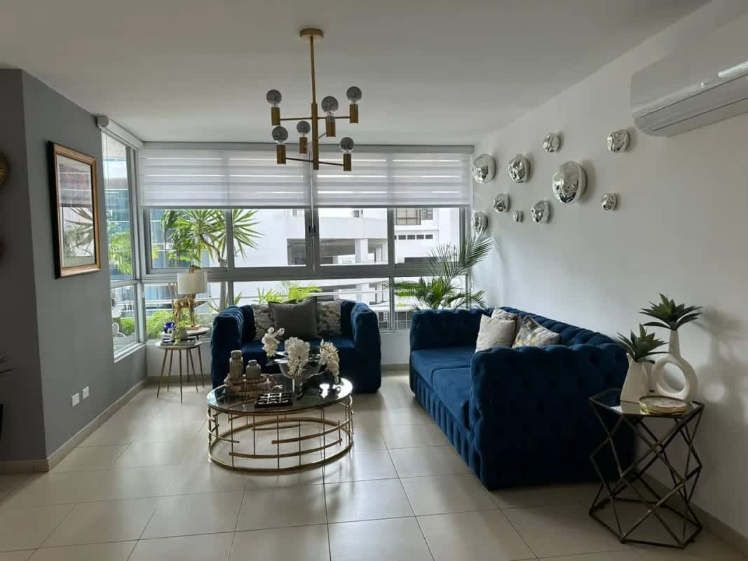 Living room with velvet sofas, decorative elements and big windows at PH Sol Marina Panama