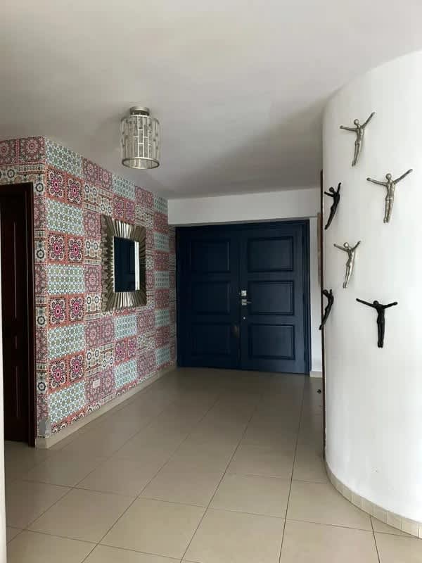 Entrance foyer with colorful accent wall and artwork at PH Sol Marina