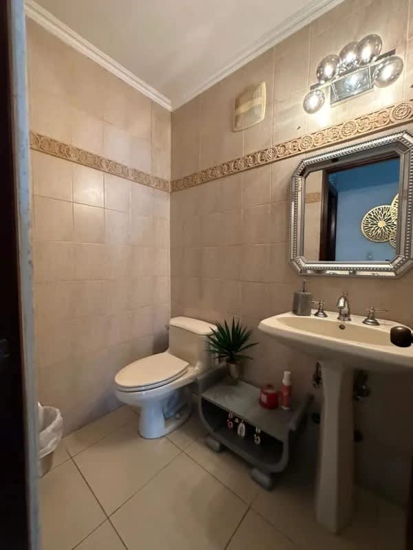 Half bathroom with pedestal sink, decorative border and tiles PH Sol Marina
