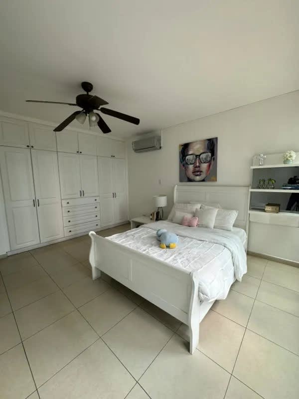 Bright bedroom with built-in wardrobe, AC, and tile floor at PH Sol Marina Marbella