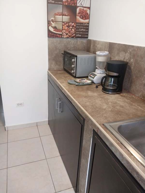 Bathroom with pedestal sink, shower curtain, fixtures at Villa Lucre Panama apartment