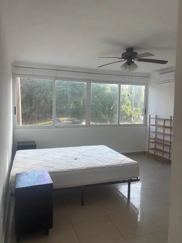 Bedroom with large windows, built-in closet, ceiling fan, minimalist decor at PH Albrook Panama