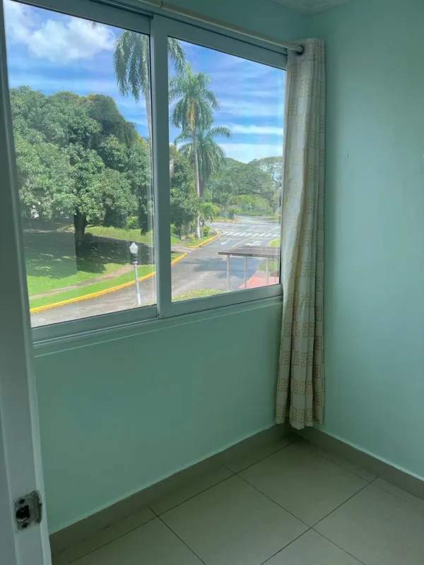 Bright corner with large window and curtain, tiled floor, sunny greenery views in PH Albrook Clayton Panama City