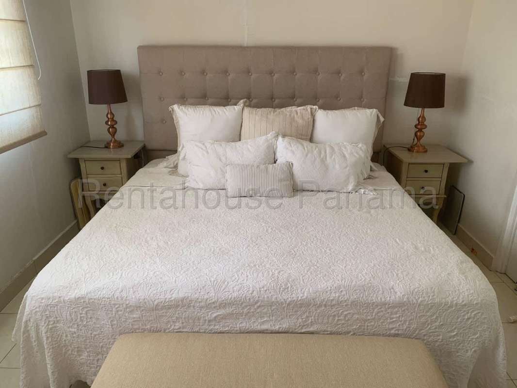 Bedroom with double bed, colorful quilt, nightstands in Condado del Rey house Panama City