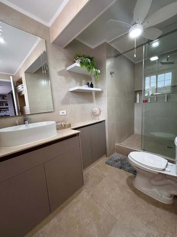 Bathroom with walk-in glass shower, vessel sink and large mirror in Cardenas Clayton home
