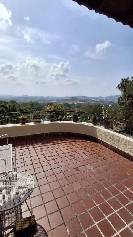 Expansive tiled terrace with views over Panama hills on property in Las Cumbres