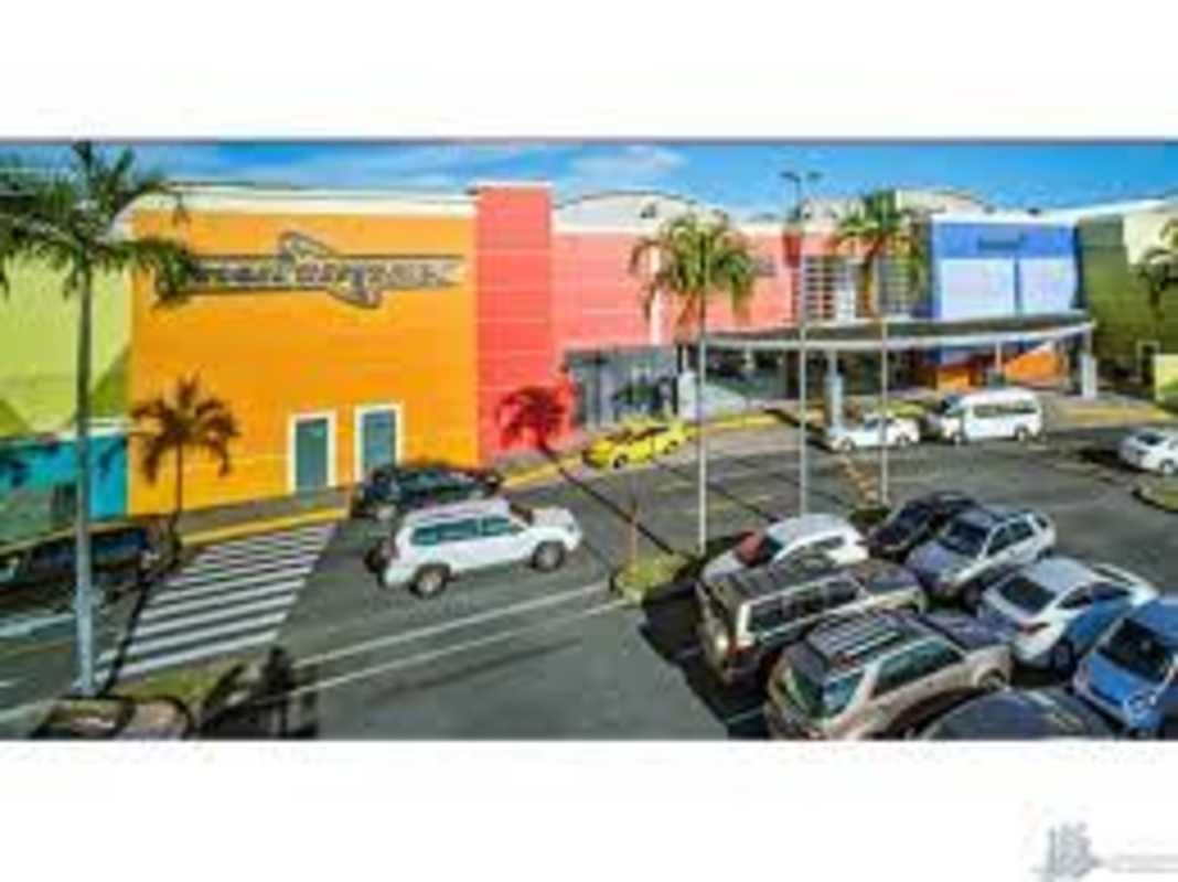 Exterior with bright signage and palm trees at Albrook Mall Panama City