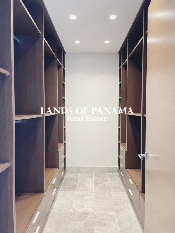 Modern spacious living room with marble floors, floor-to-ceiling windows overlooking golf course in Santa Maria Panama