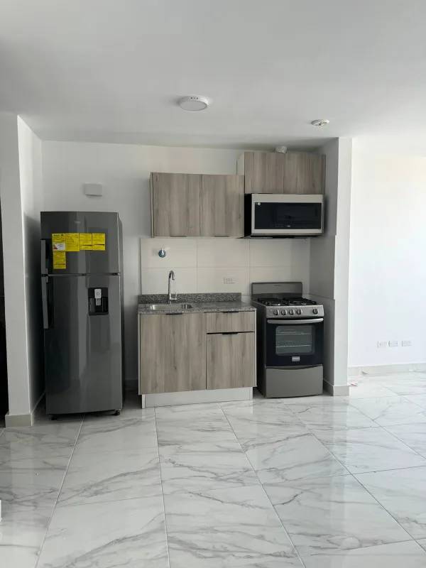 Modern kitchen with granite countertops, light cabinetry and appliances in PH The Gray Panama City