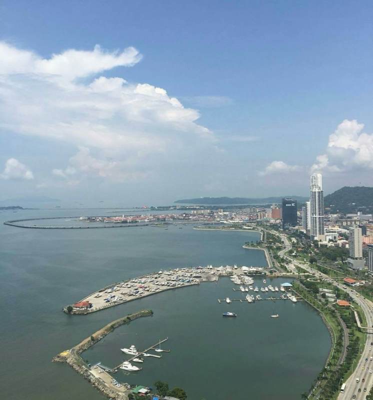 Modern living room with floor-to-ceiling windows and ocean view in PH Yoo Panama