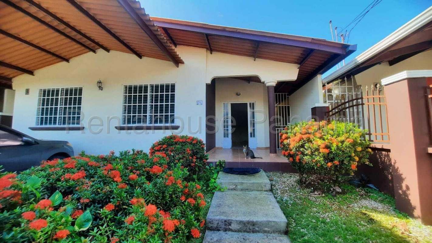 Covered garage parking and front garden in Brisas del Golf rent to own house Panama