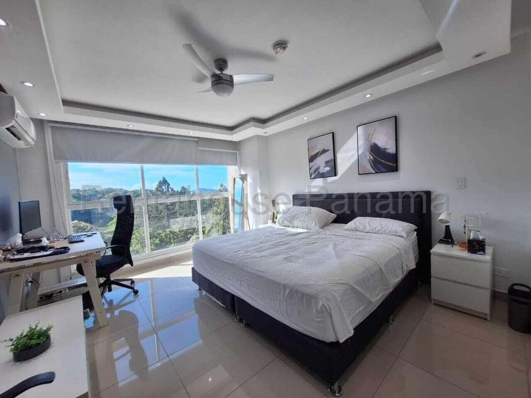 Bedroom with desk, city view and Ancon Hill nature Ancon Reserve Panama rental apartment