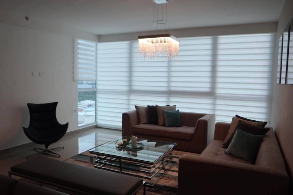 Bright spacious living area with panoramic windows, city views in PH Costa del Este apartment Panama