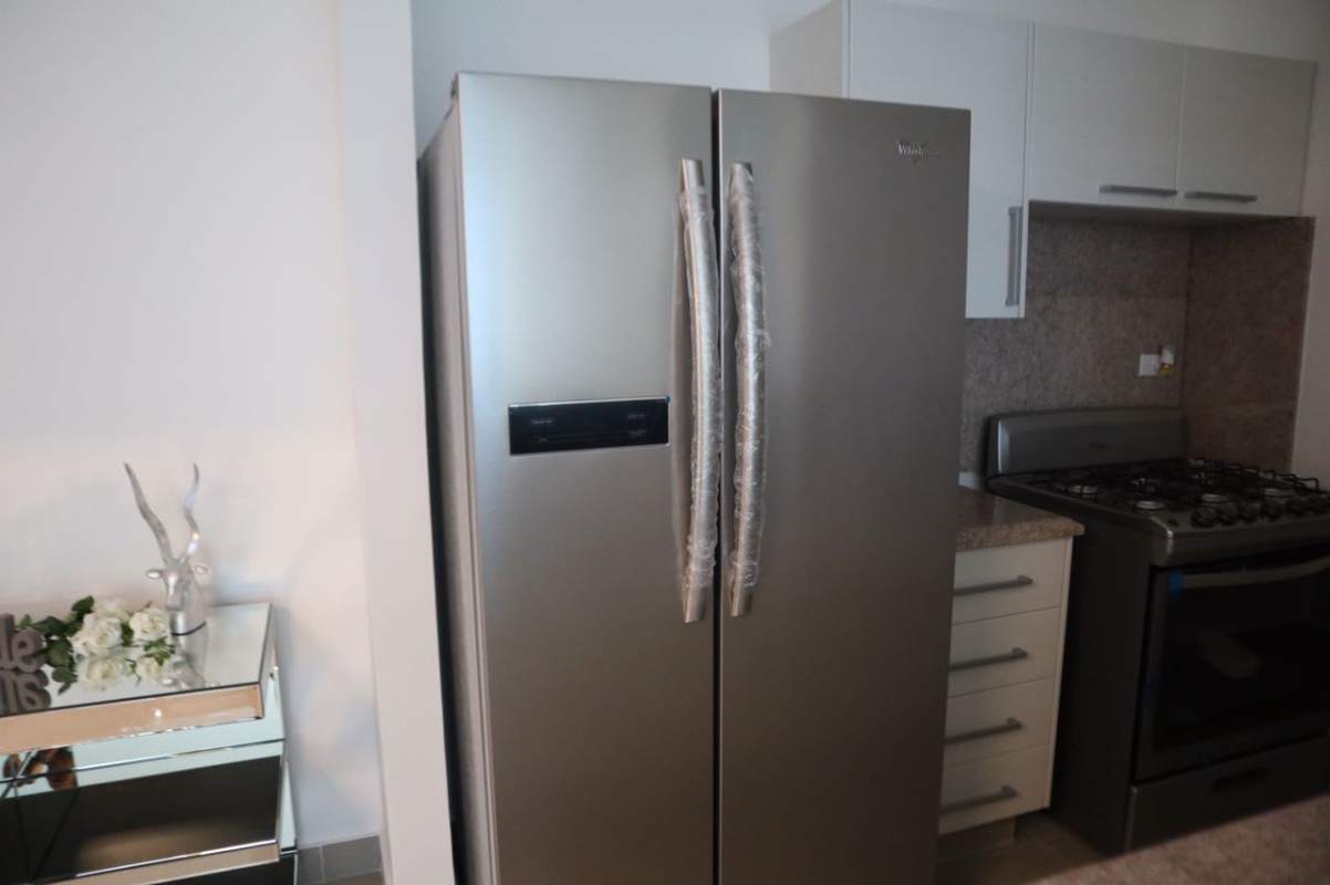 Elegant tower lobby of PH Costa del Este apartment rental Panama City with security desk