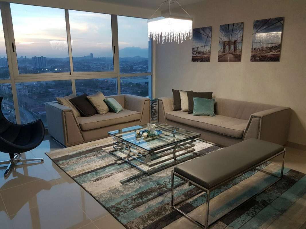 Large outdoor swimming pool and lounge area with skyline backdrop Costa del Este Panama