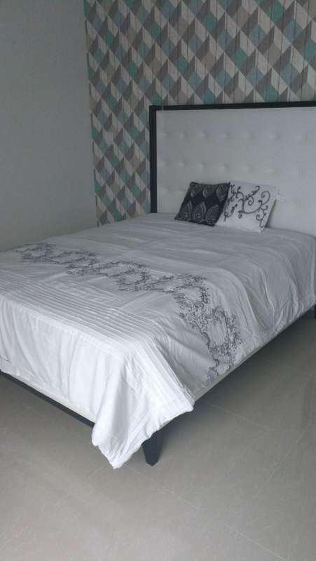 Furnished bedroom with modern decor and floor to ceiling windows at PH Costa del Este Panama City