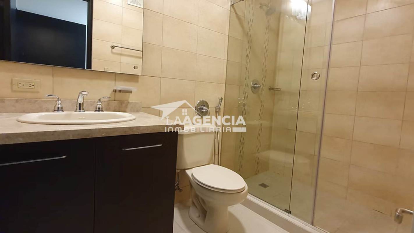 Bathroom with granite vanity and glass shower at Embassy Village Panama