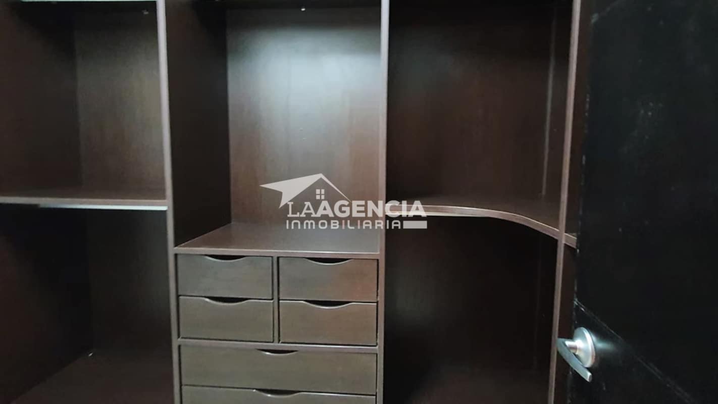 Spacious wooden built-in closet with shelves and drawers at Embassy Village Panama