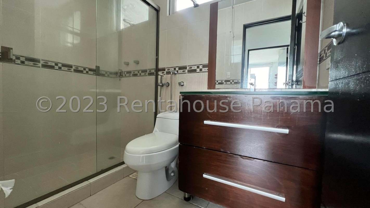 Bathroom with glass shower, vanity sink, tiled wall at PH Clayton Park Tower Panama