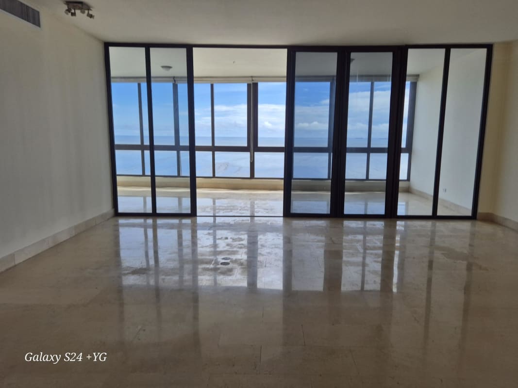 Kitchen with black granite counters, wood cabinetry, large window city view PH Panama Bay Costa del Este Panama