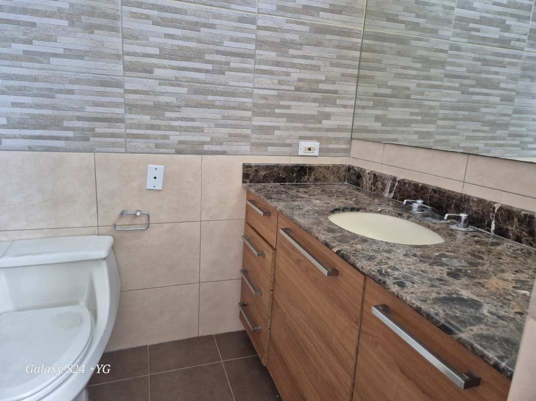 Bathroom featuring marble countertop, wood vanity, mosaic tile wall PH Panama Bay Costa del Este