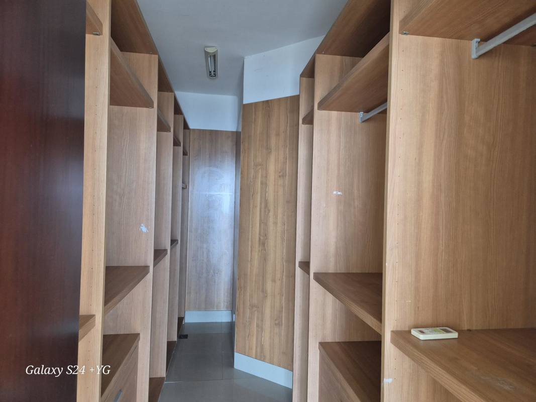 Walk-in closet with ample wood shelving and storage PH Panama Bay Costa del Este